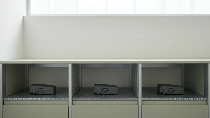 DJI Air 3 batteries resting separately in a dry ventilated equipment cabinet