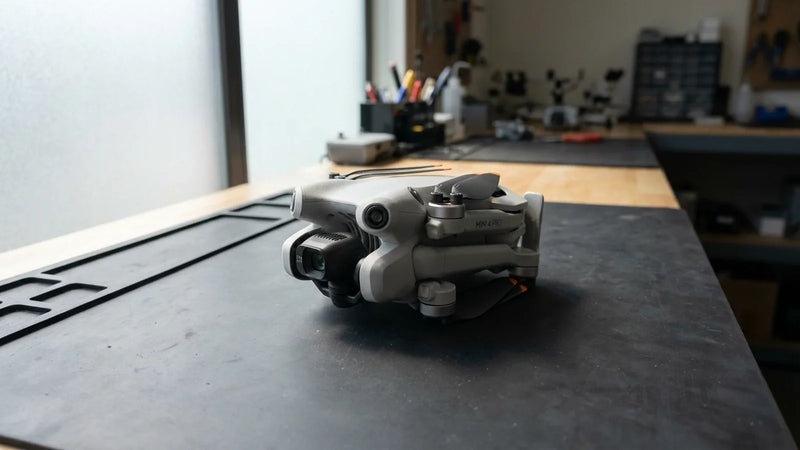 Powered-off DJI Mini 4 Pro held for a documented no-charge diagnosis