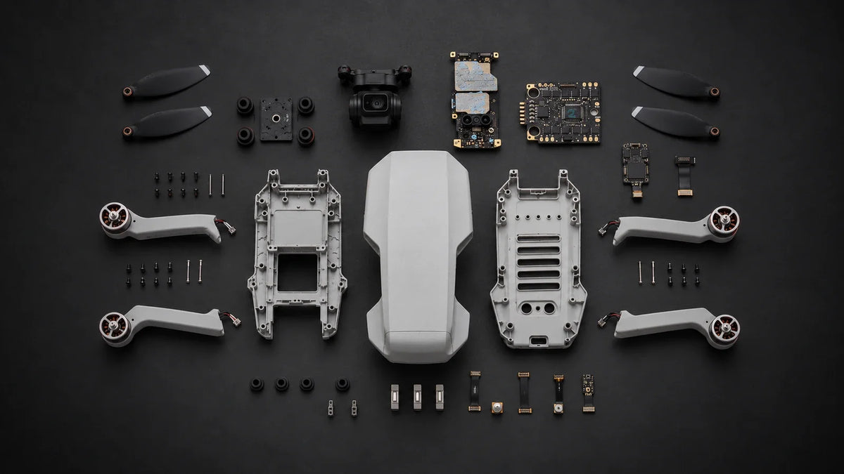 Top-down layout of DJI Mini 2 SE shells, folding arms, camera and electronic repair components on a dark charcoal background.
