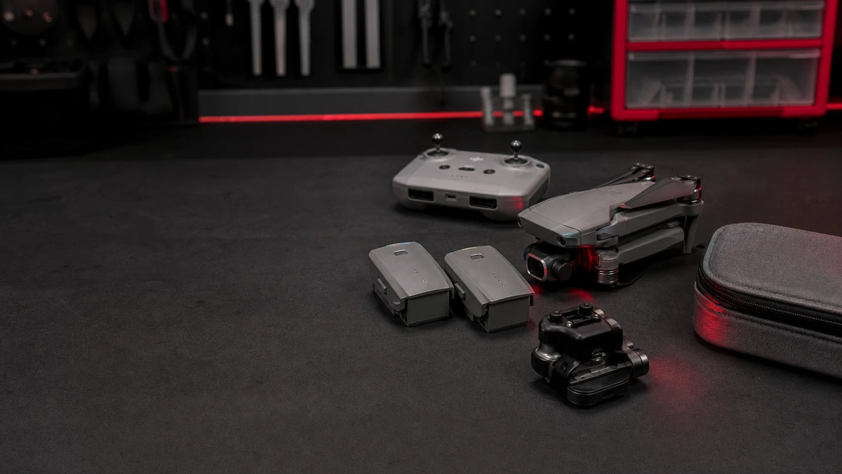 Weekly Drop: selected drone, controller, batteries and travel case on a Reboot Hub repair workbench
