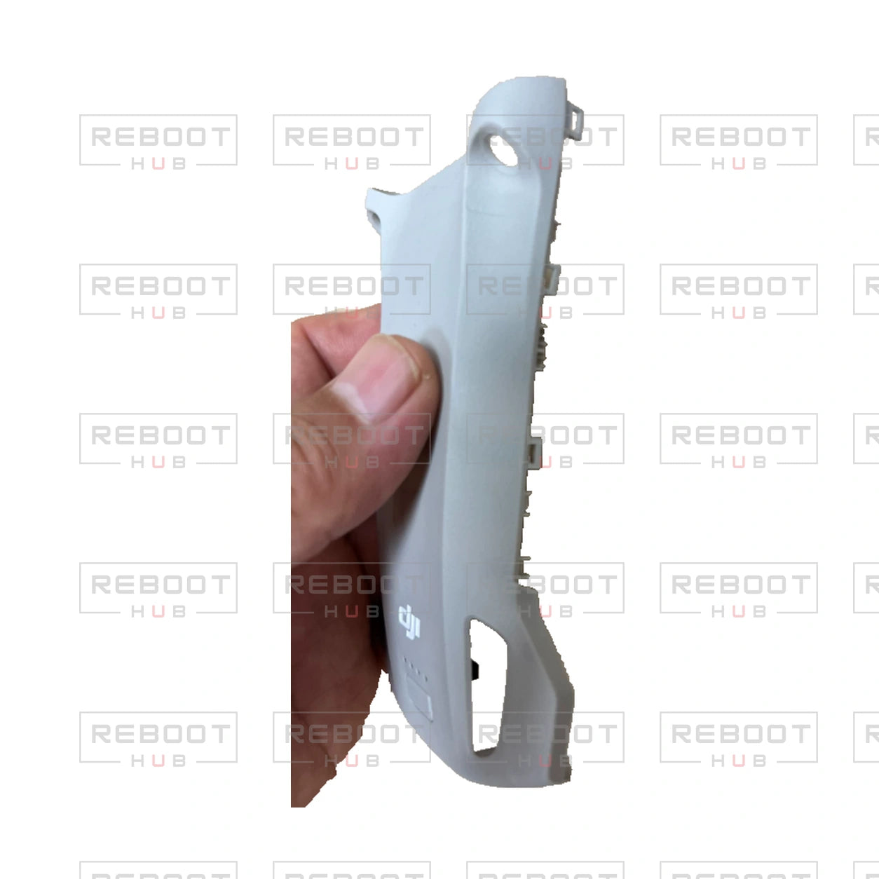 DJI Mini 3 Pro upper shell, original handheld side view with the actual thumb occlusion retained, on white with Reboot Hub watermark overlay