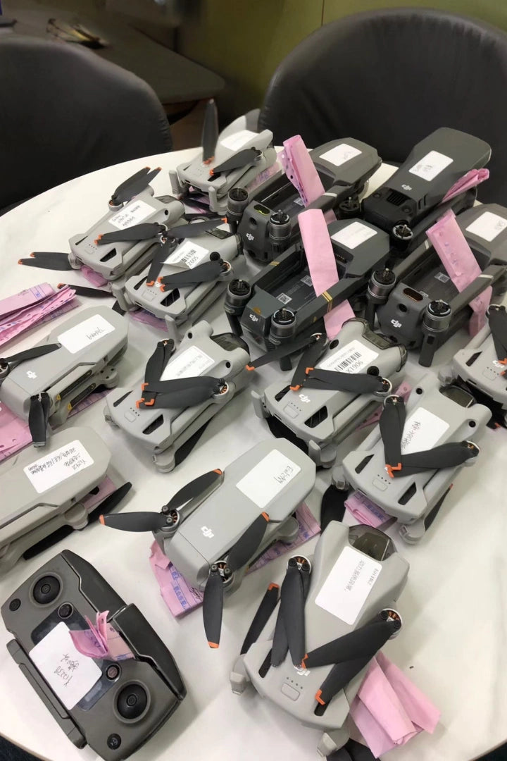 DJI drones organized for inspection and repair at Reboot Hub