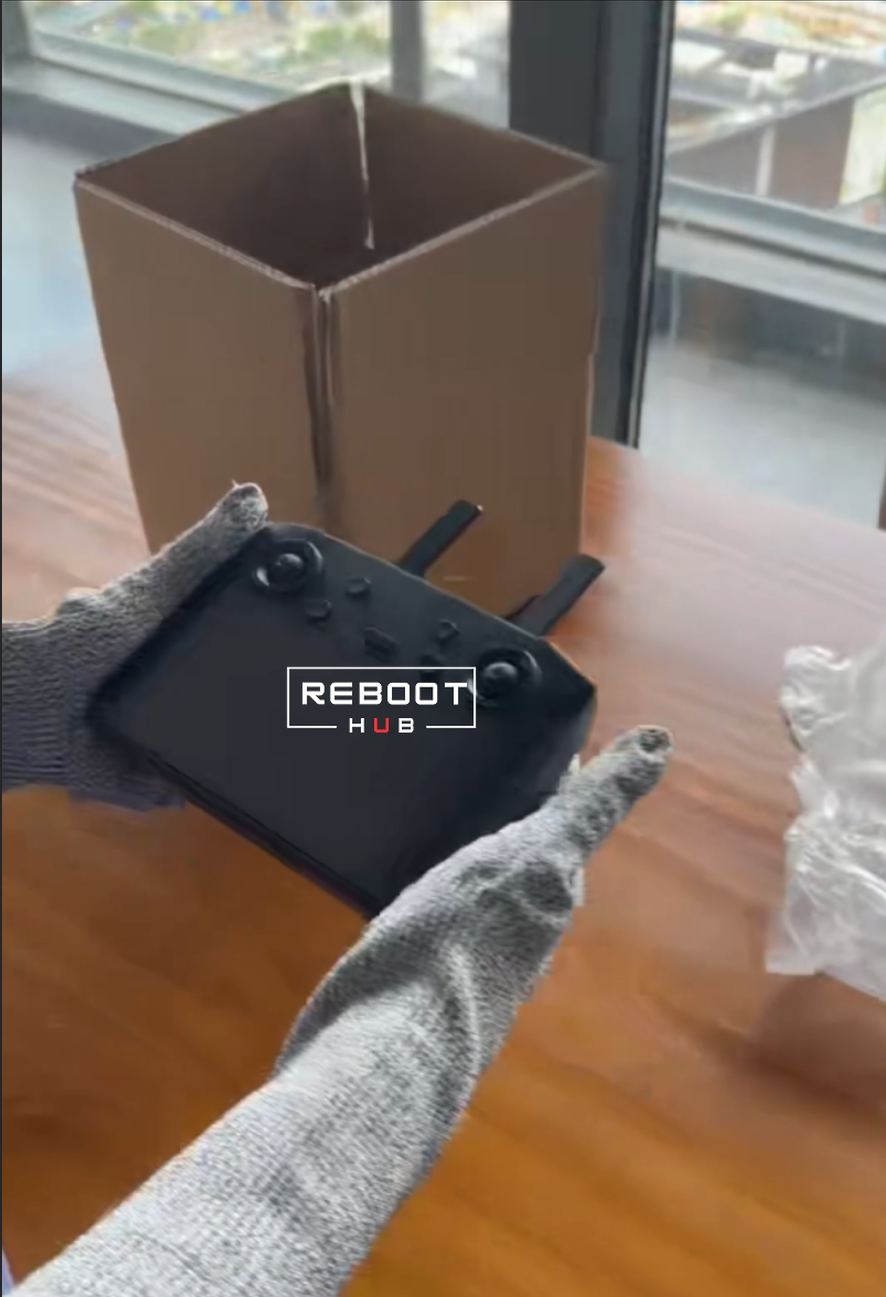 A Reboot Hub team member prepares a controller for protective packaging.